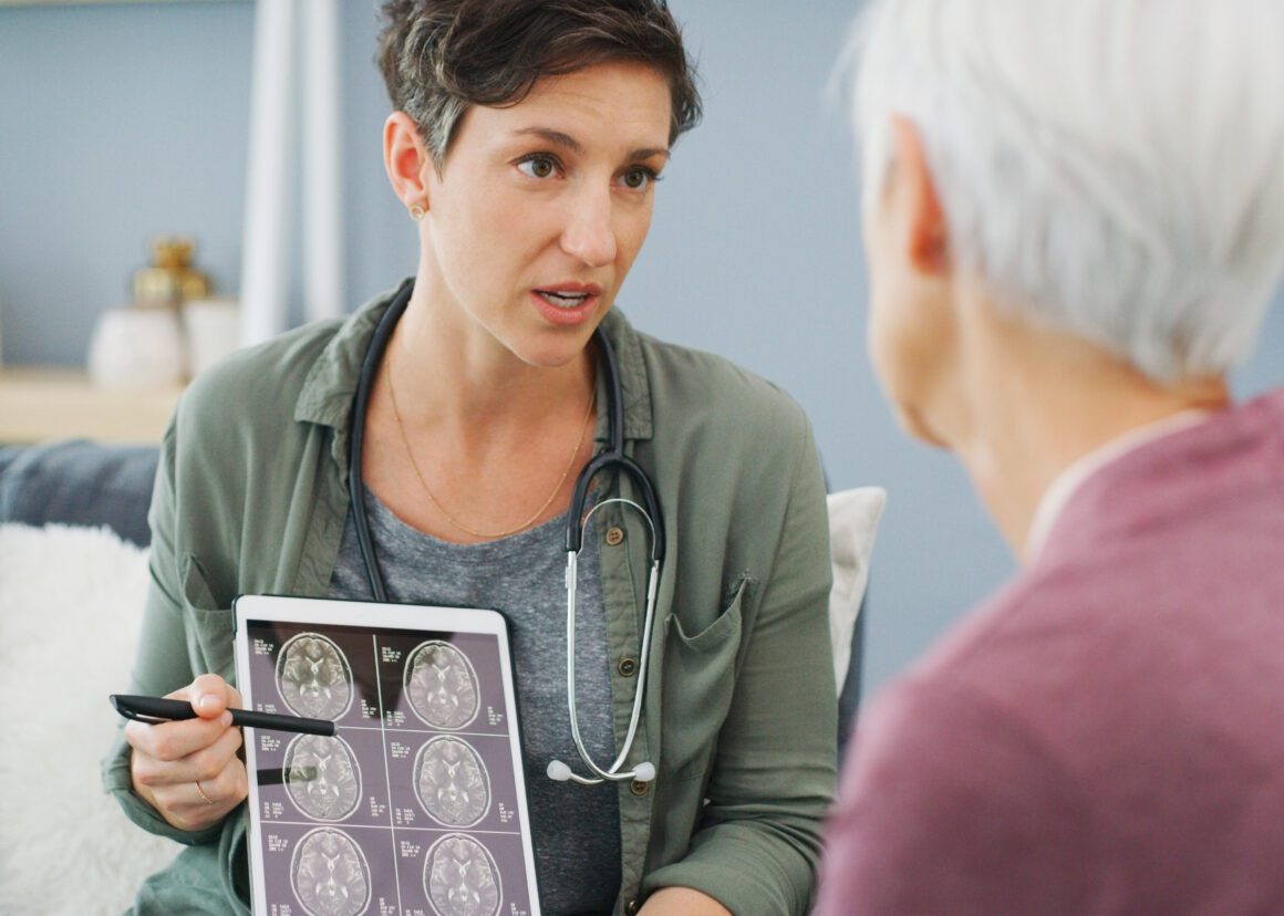 A woman is talking to a doctor about a mri scan.