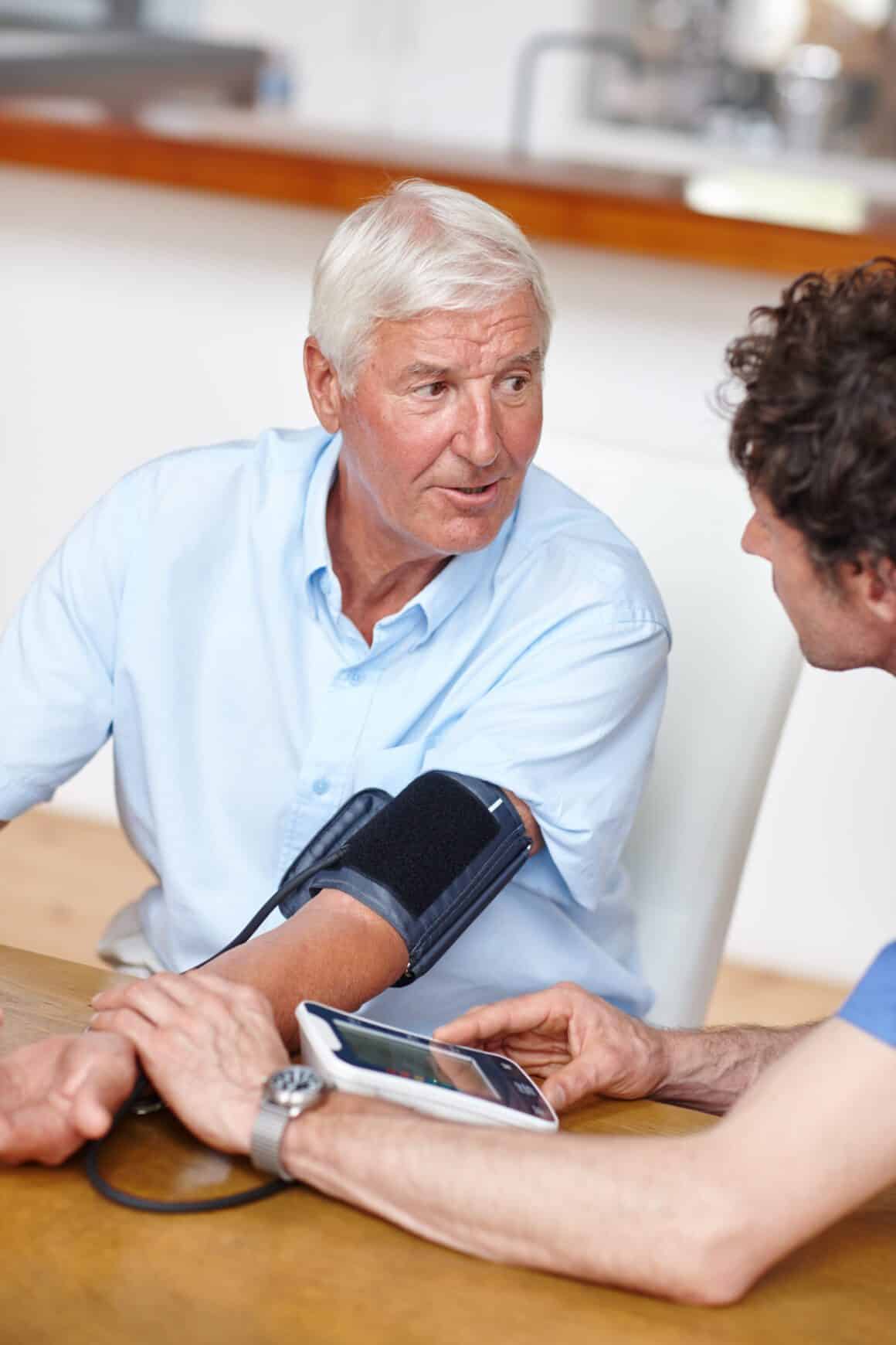 Health Check-ups a doctor checking a patient's blood pressure.